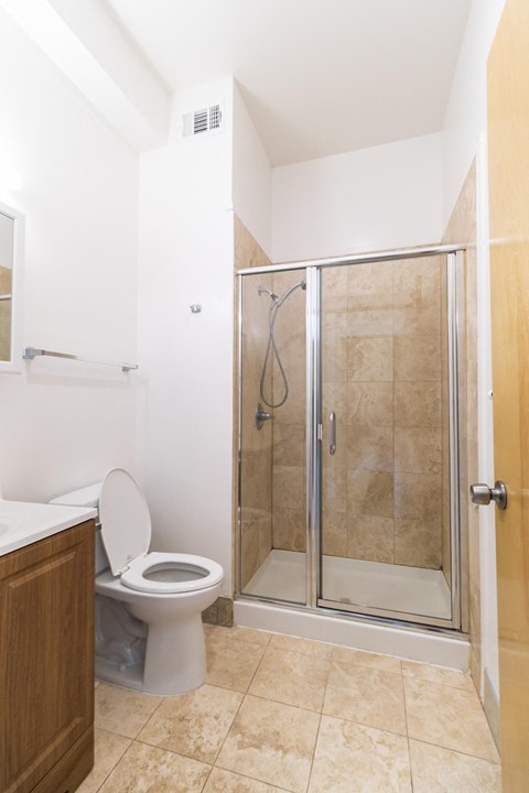 a small bathroom with a shower and a toilet
