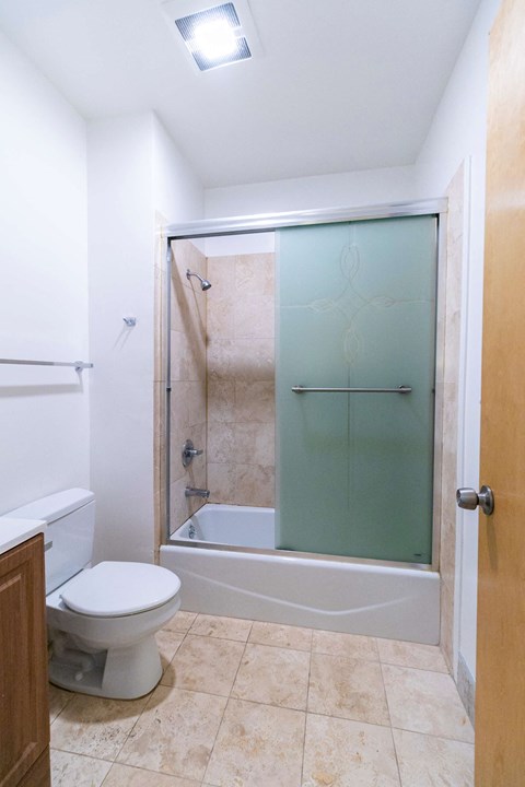 a bathroom with a toilet and a shower