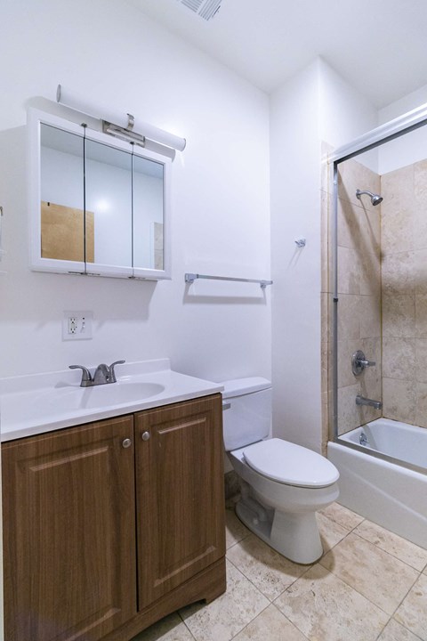 a bathroom with a sink toilet and a shower