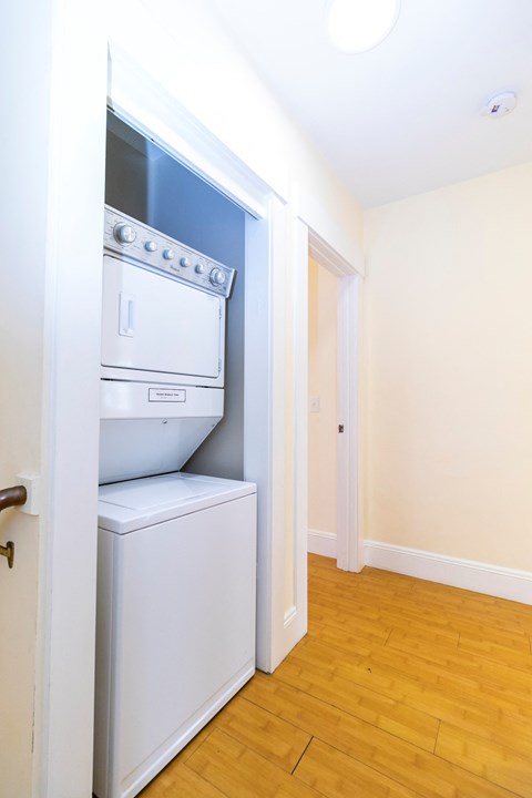 a laundry room with a washer and dryer and a door to a closet