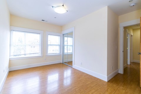 the living room and dining room of an empty apartment