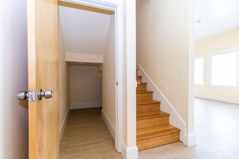 an open door leading to a staircase in a house