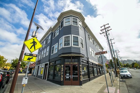 a black building on the corner of a city street
