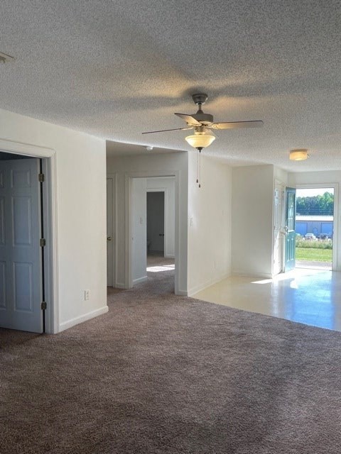 A room with a ceiling fan and carpeted floor.