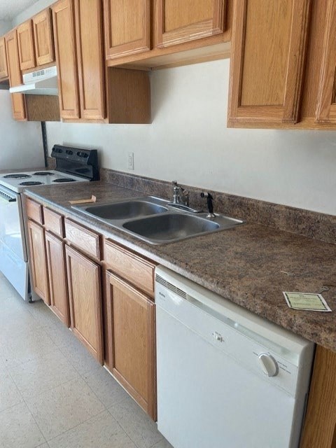A kitchen with wooden cabinets and a white dishwasher.