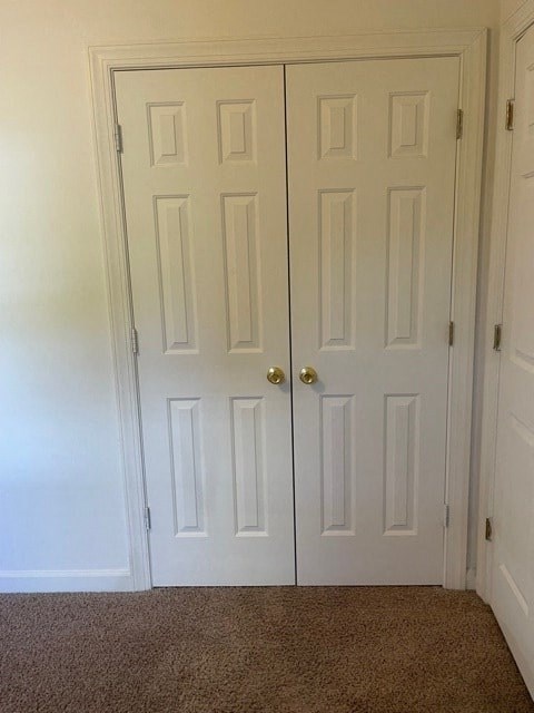 A pair of white doors with gold handles.
