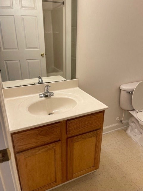 A white sink with a wooden cabinet below it.