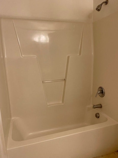 A white bathtub with a silver faucet.