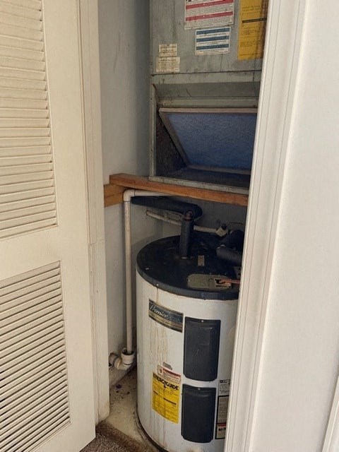 A white wall with a window covered in blinds and a white door.