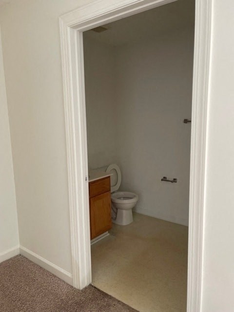 A bathroom with a toilet and a sink.