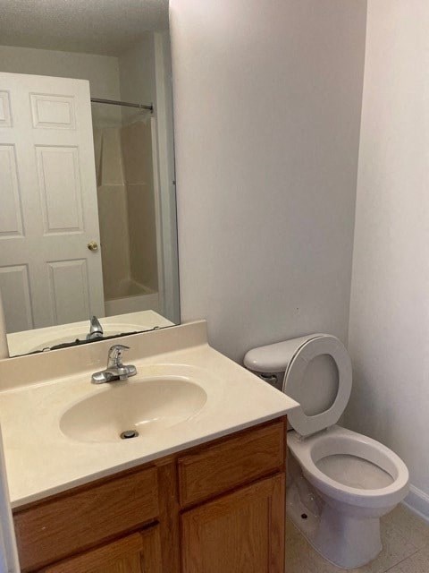 A white toilet sits next to a sink in a bathroom.