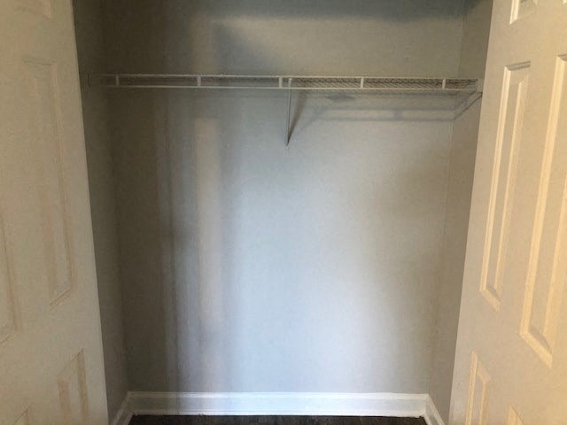 A metal shelf in a room with white walls.