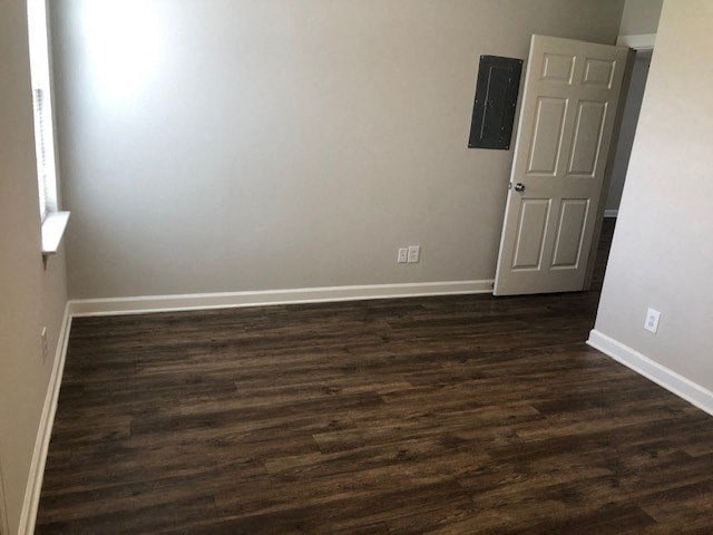 A room with a wooden floor and a white door.