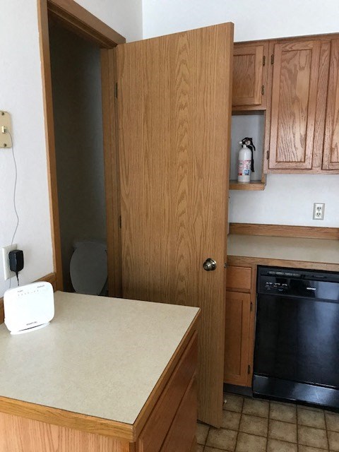 a kitchen with a counter and an open door