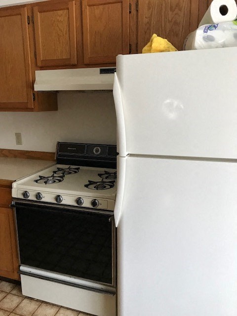 a kitchen with a stove and a refrigerator
