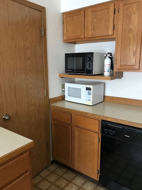a small kitchen with a microwave on the counter