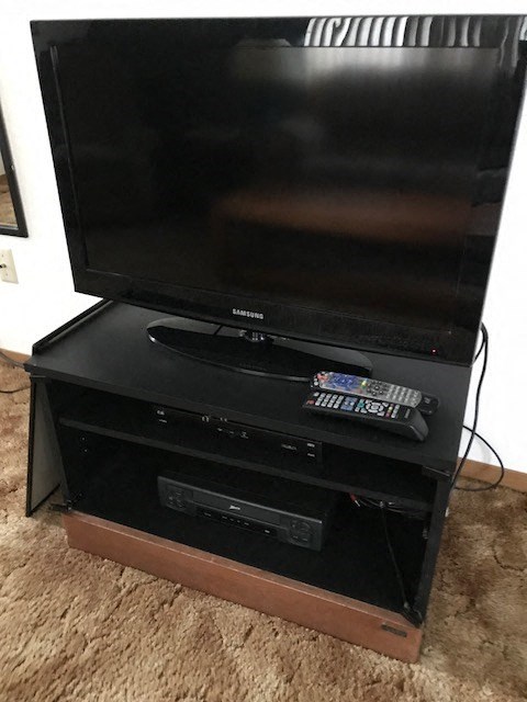a television sitting on top of a black stand