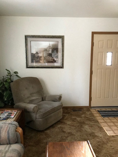 a living room with a chair and a table