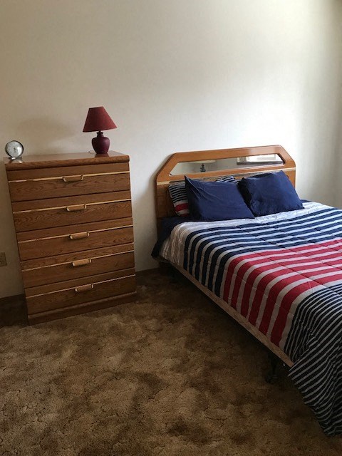 a bedroom with a bed and a dresser