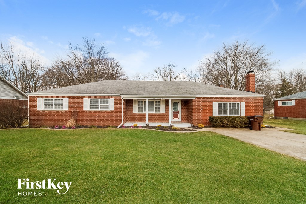 A brick house with a white door and a small porch.
