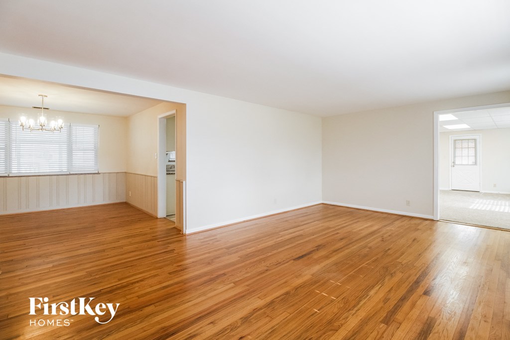A room with wooden floors and a chandelier.