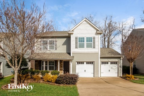 A two-story house with a garage is for sale.