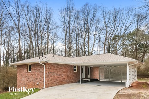 the front of a brick house with a garage door
