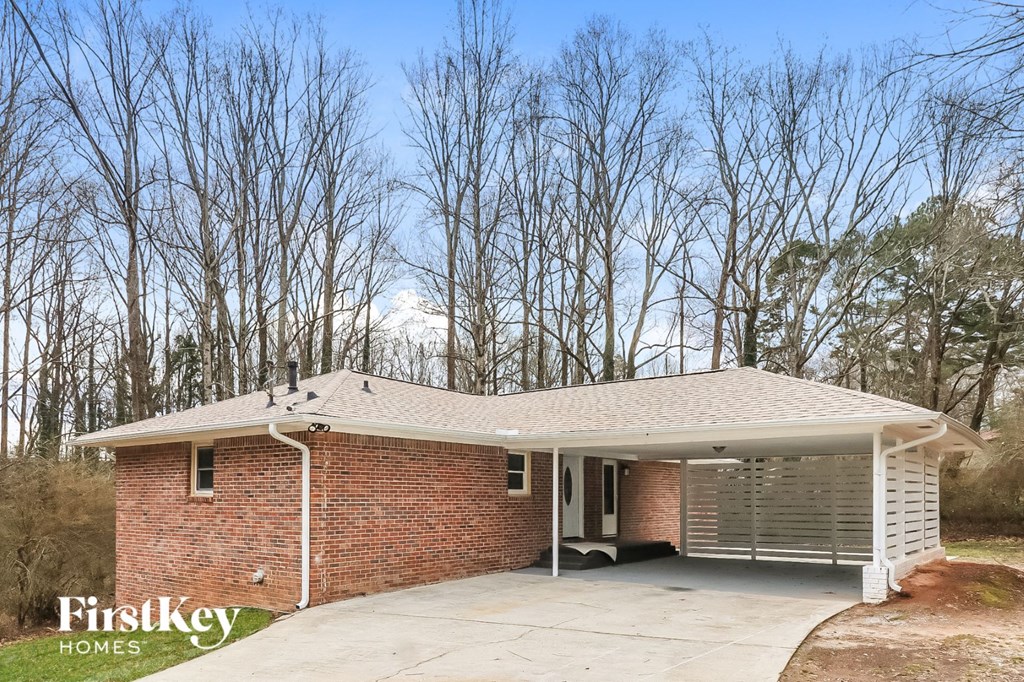 the front of a brick house with a garage door