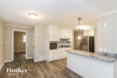 a kitchen with white cabinets and a counter top