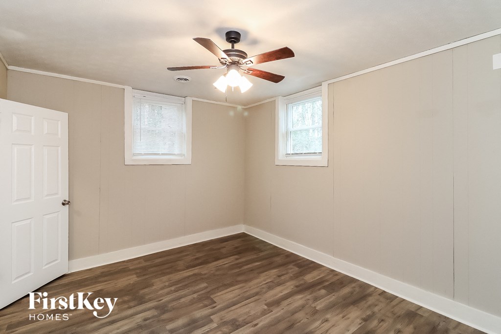 the interior of a bedroom with a ceiling fan