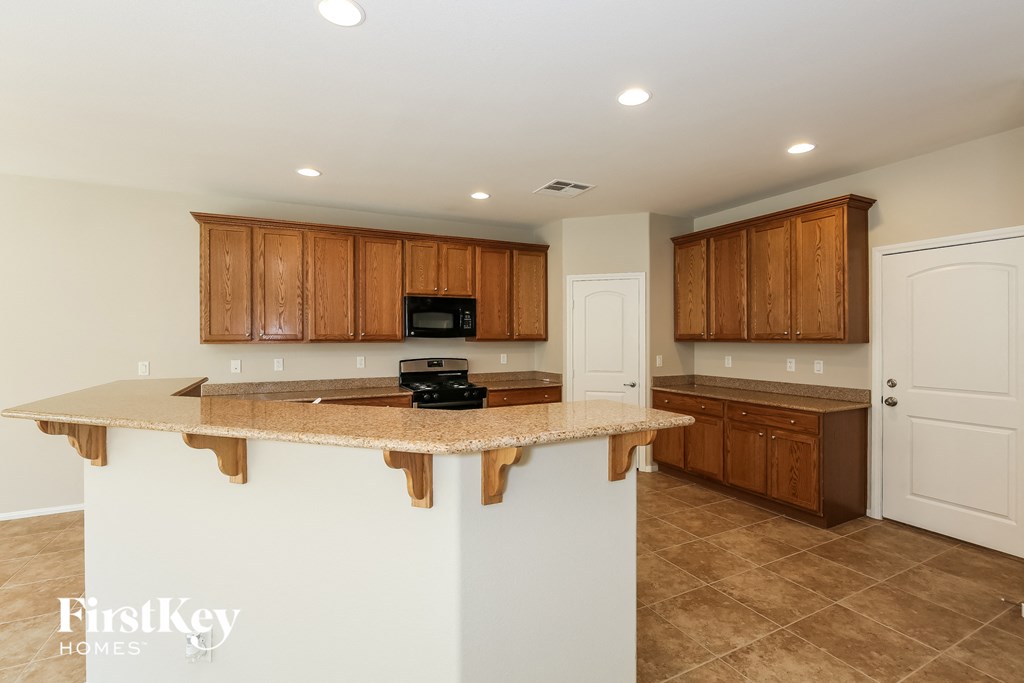 a kitchen with brown cabinets and a counter top