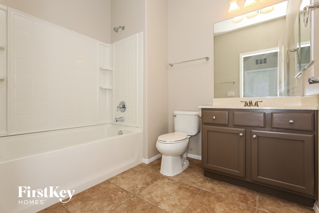 a bathroom with a toilet and a tub and a sink