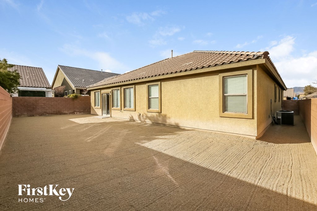 a home with a driveway and a yellow house