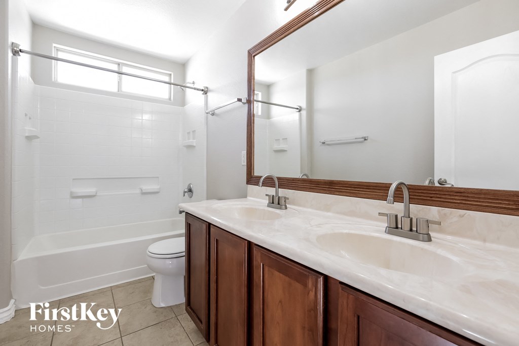 a bathroom with a sink and a shower and a toilet