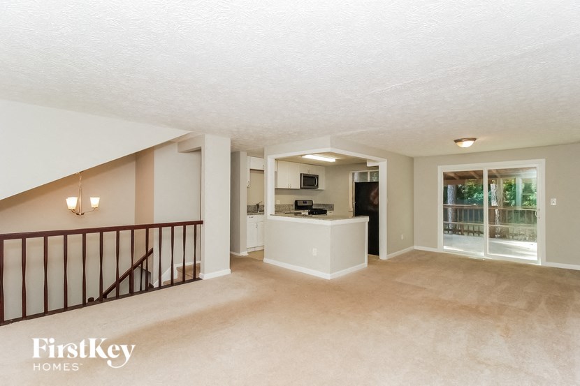 the spacious living room and kitchen in this home for sale