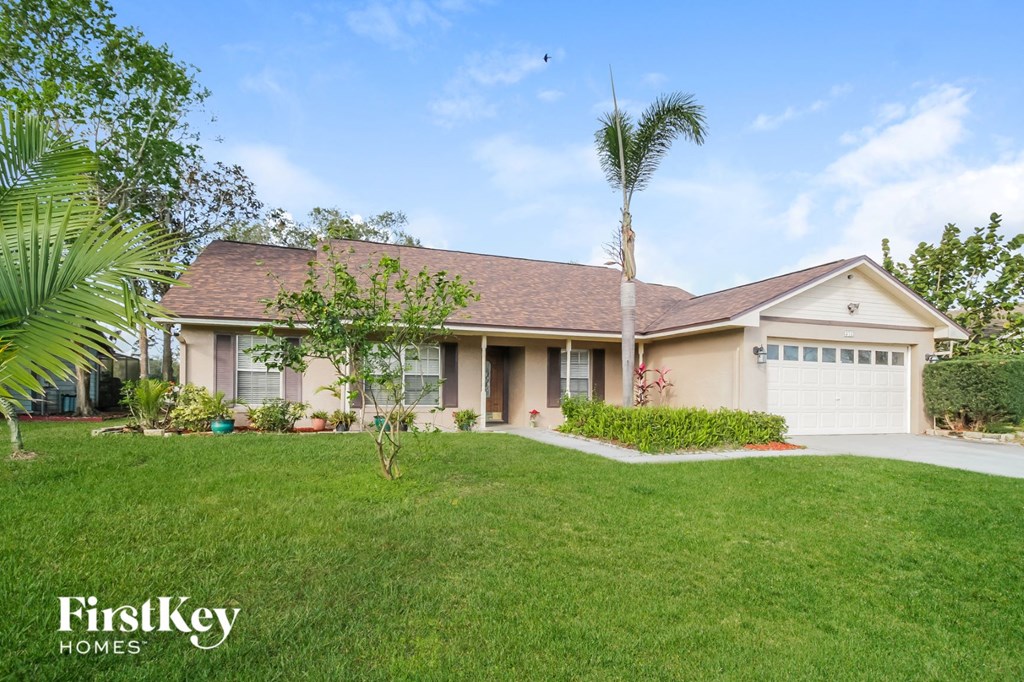 A house with a brown roof and a white garage door is for sale.
