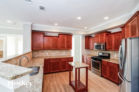 a kitchen with wooden cabinets and stainless steel appliances