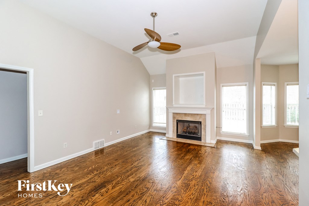 a living room with wood floors and a fireplace