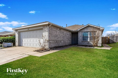 a house with a lawn and a garage door