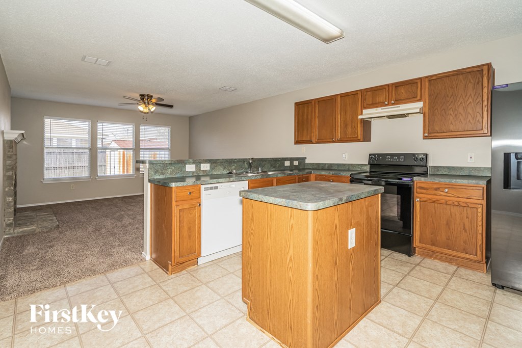 a kitchen with wooden cabinets and a counter top