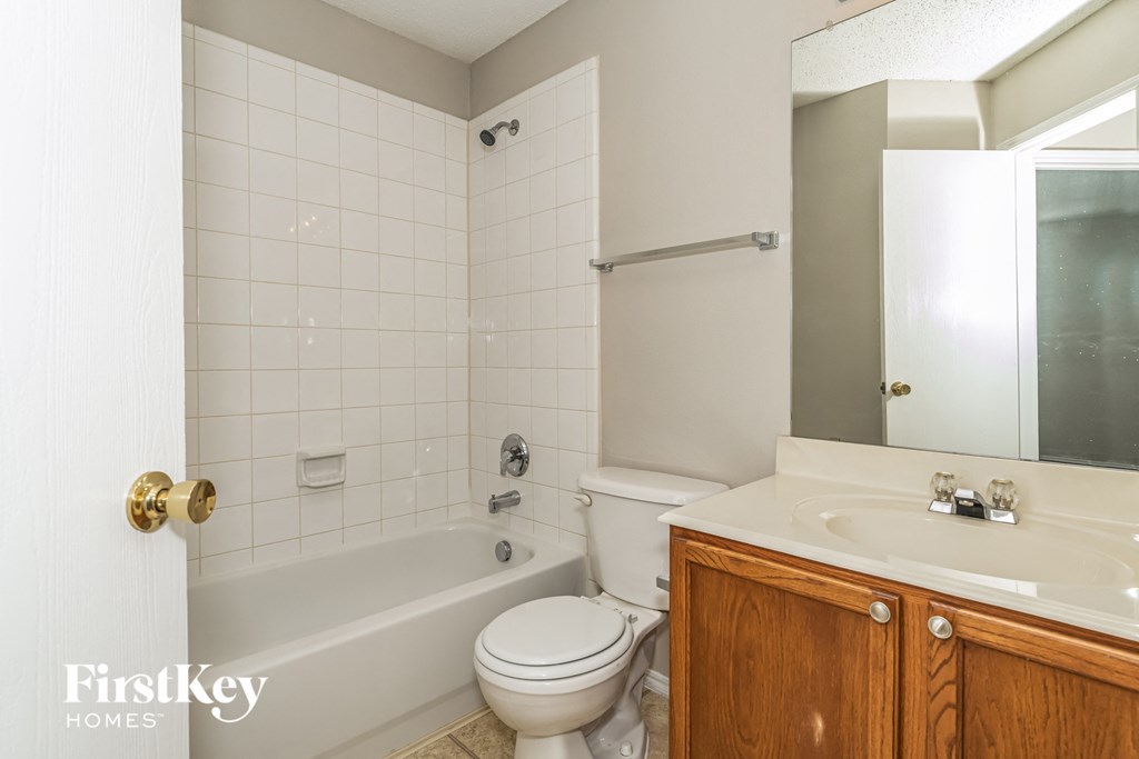 a bathroom with a toilet and a sink and a tub
