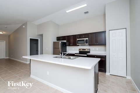 a kitchen with a white counter top and a sink