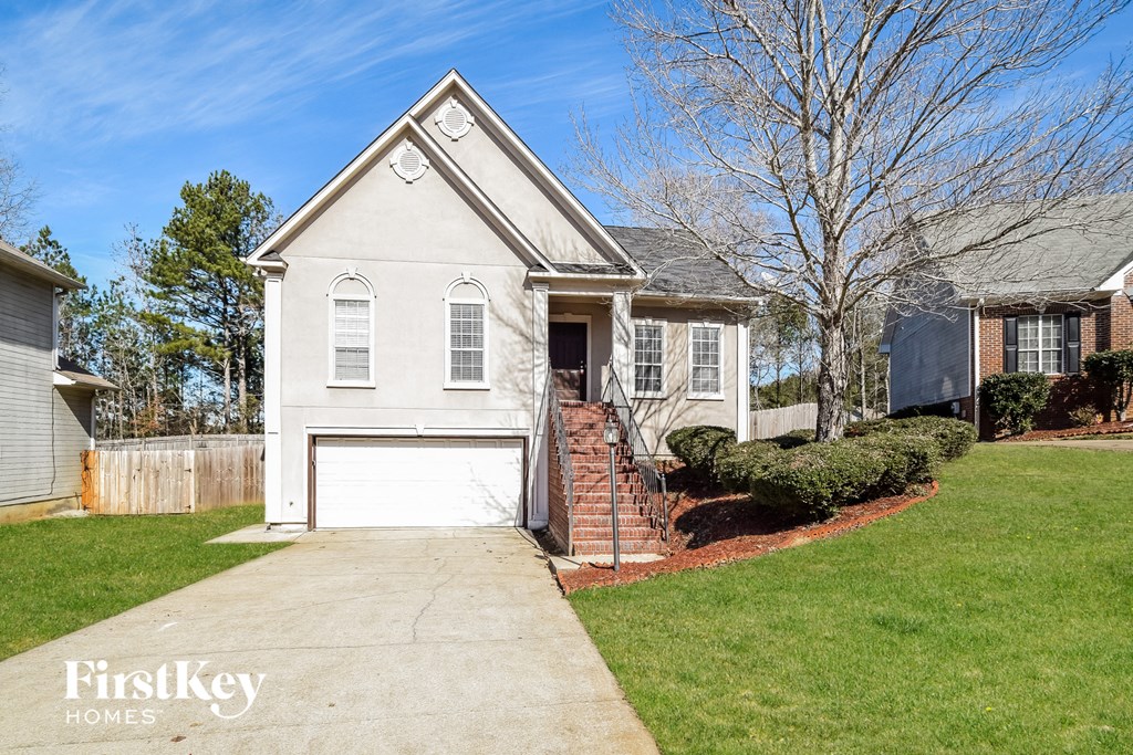 a small white house with a white garage door