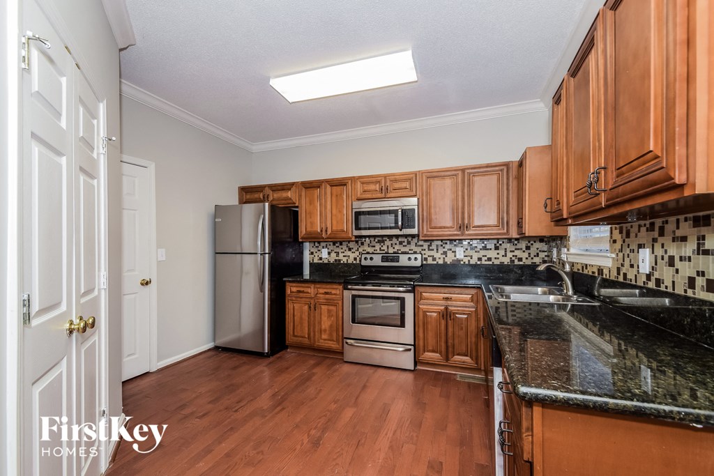 a kitchen with wooden cabinets and stainless steel appliances