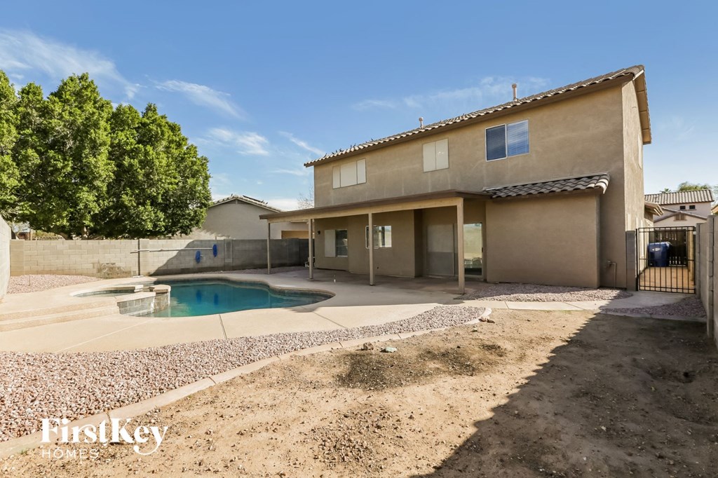 a backyard with a pool and a house