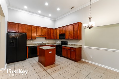 a kitchen with black appliances and wooden cabinets