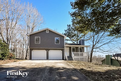 a gray house with a garage and a driveway