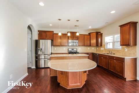 A kitchen with wooden cabinets and a central island.