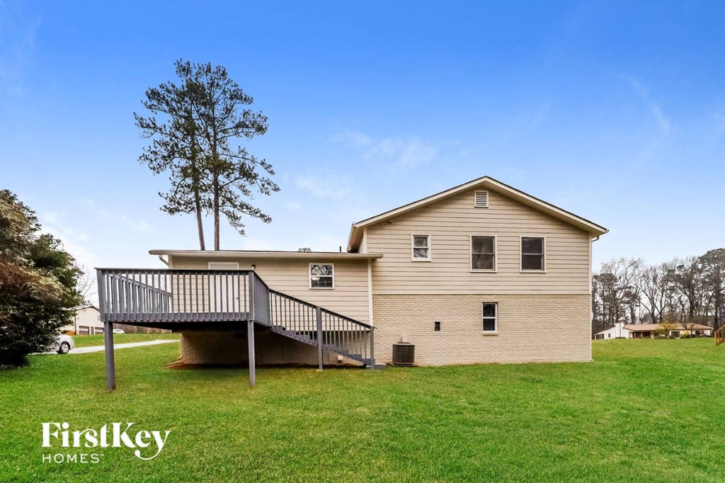 a house with a deck and a tree