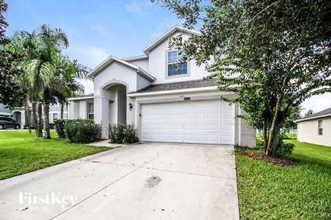 a white house with a driveway and a garage door